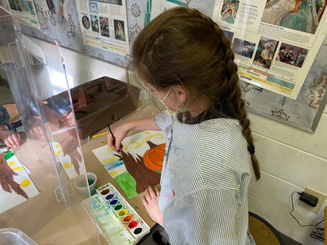 Student painting a picture